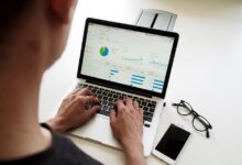 A person using a laptop displaying a graph, illustrating a knowledge management tool in action.